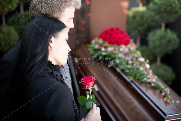 Religion, death and dolor - funeral and cemetery; funeral with coffin, stock photo