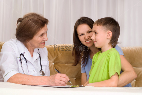 Doctor and mom with a boy, stock photo