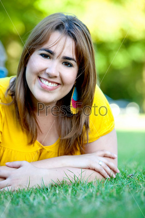 Happy woman portrait smiling in a park