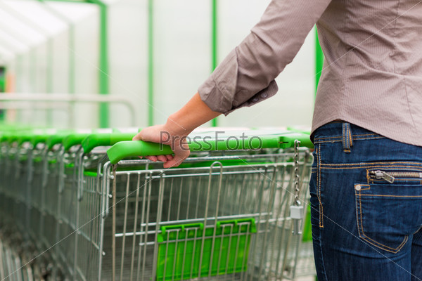 Woman in supermarket with shopping cart
