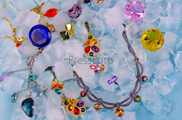 Jewels at blue cube of ice background