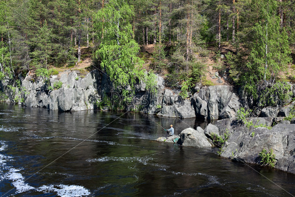 Fisherman catching fish on stream river water at the day