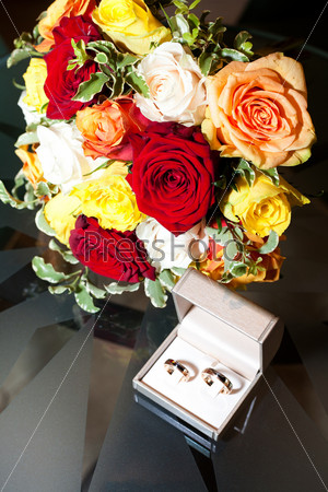 Bridal bouquet and a ring on the table