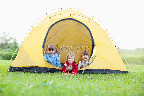 Happy children in tent. Family outdoors