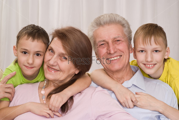 happy family of four on a white background