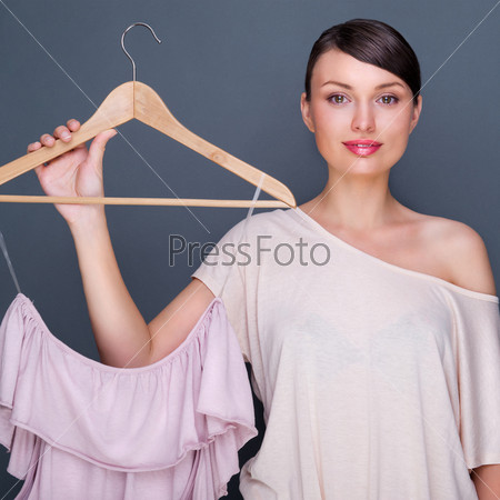 Portrait of pretty fashionable woman trying new clothes. Fashion