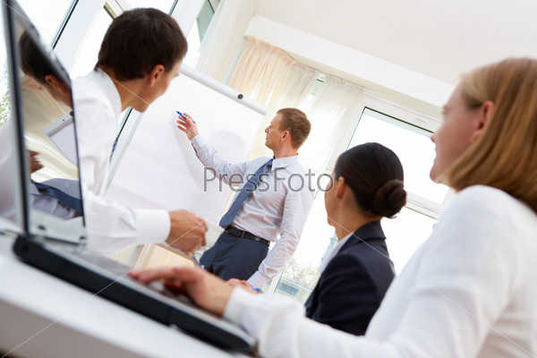 Businessman presenting the project to the team of co-workers, stock photo