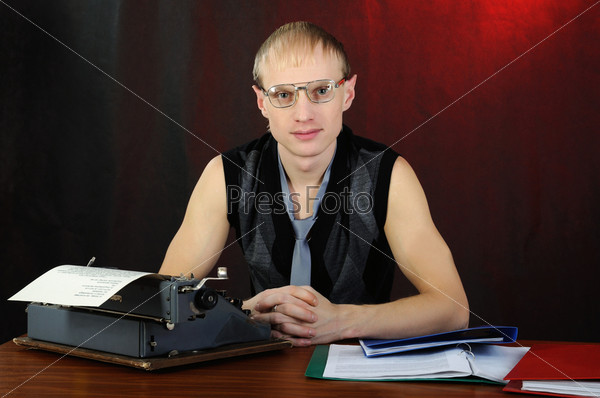 Man in eyeglasses with old typewriter.