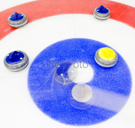 Blue stone taking the house by tapping away a yellow stone at a curling game