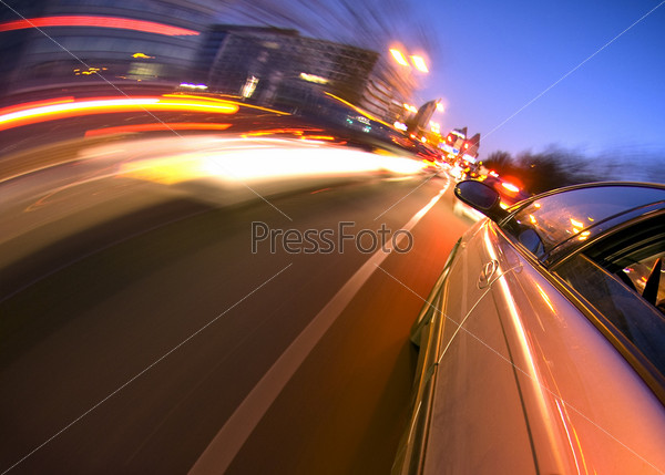 A car driving in the busy downtown streets, anticipating oncoming traffic