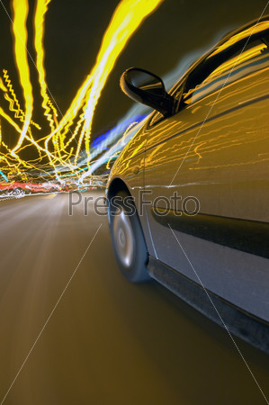 A car finding its way through the downtown traffic amidst the clutter of lights