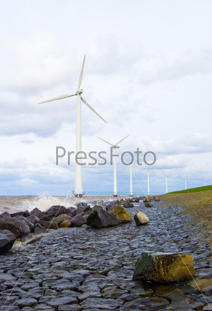 The wind turbines along a Dyke in the Netherlands