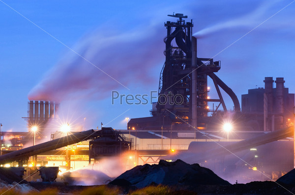Heavy industry at night with a blast furnace dominating the scene