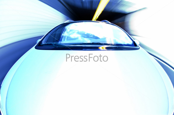 A car exiting a tunnel. The effect is created with the whitebalance and using a high key - overexposure. Intended as-is.