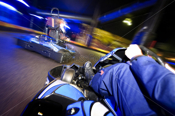 Go-carts in pursuit on an indoor race track