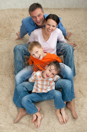 Family of four sitting on the carpet