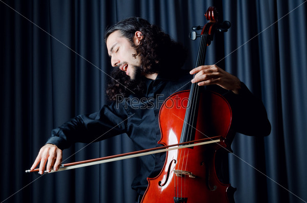 Cello player during performance, stock photo