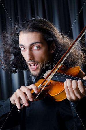 Young violin player playing, stock photo