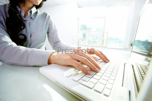 Business lady typing on laptop at office
