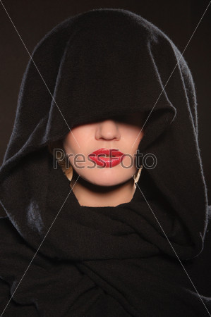 portrait of beautiful woman in cape on dark background