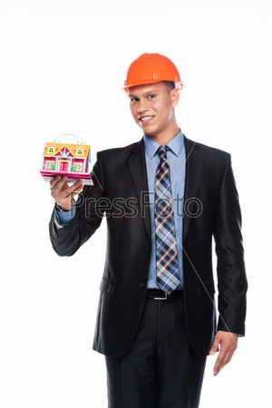 Stock Photography of property insurance - young man in a helmet with the layout...