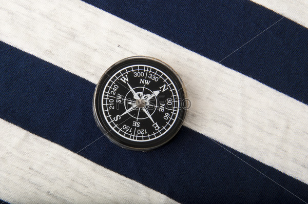 Old compass on the background of a sailor dress
