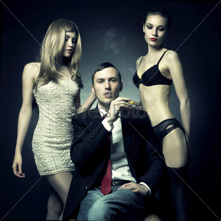 Fashion photo of handsome man and two women