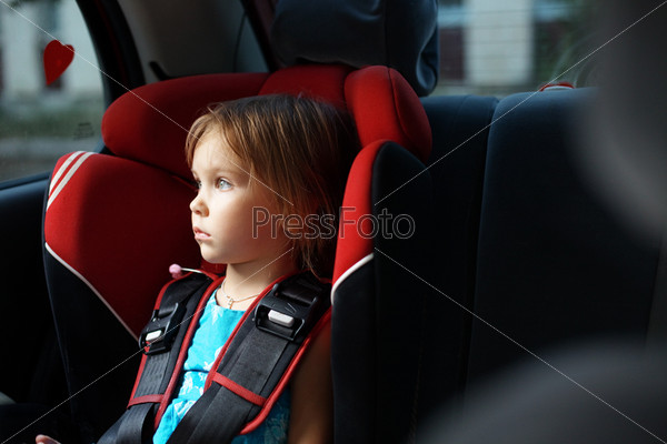Child in auto baby seat in car