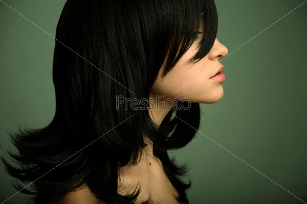 Elegant girl with magnificent black hair. Studio portrait.