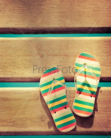 Beach flip flops on wood. Summer vacations background