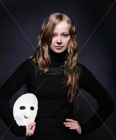 Low key portrait of a beautiful girl with mask