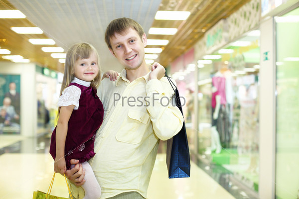 Young family with shopping bags doing shopping