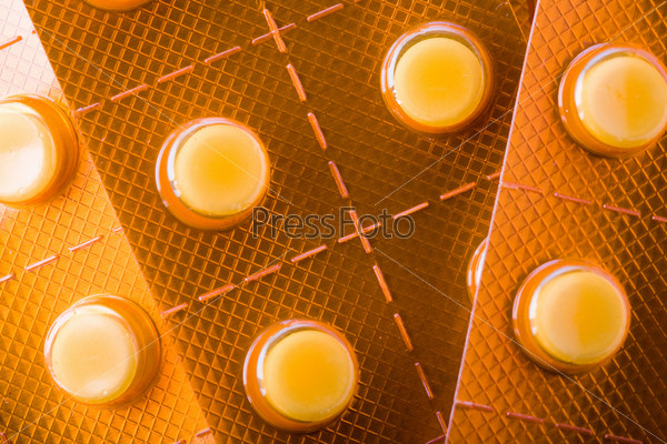 Stock photo: health theme: an image of orange tablets closeup