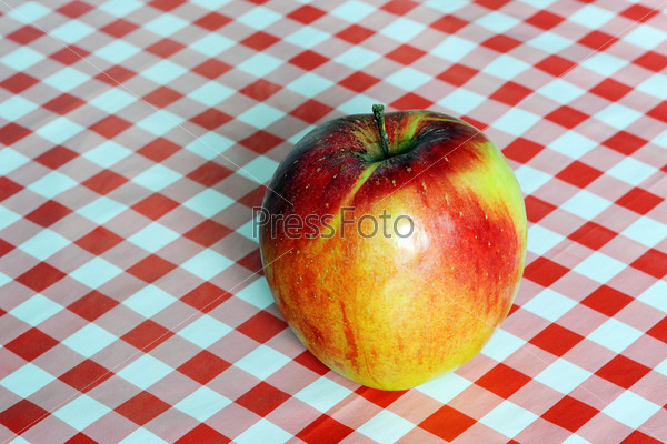 An image of a big red ripe apple on a table, stock photo
