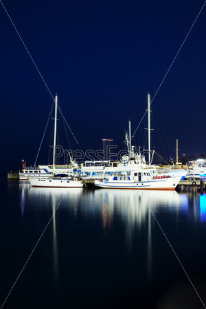 Yachts near the pier. Shot at night.