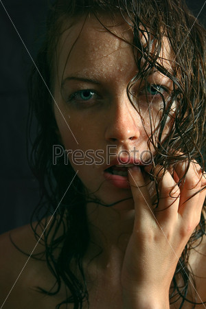 Wet woman portrait with water drops on the face