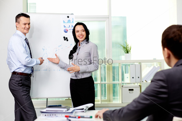 Confident business partners carrying out presentation of business plan to manager