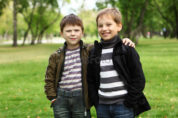Boy with a friend in the green park, stock photo