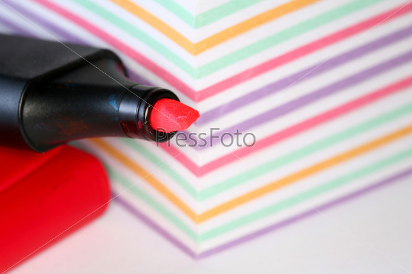 Closeup image of red pen on background of sheets