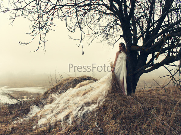 woman in white dress in the winter on the hill