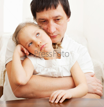 Father comforts a sad girl. Problems in the family