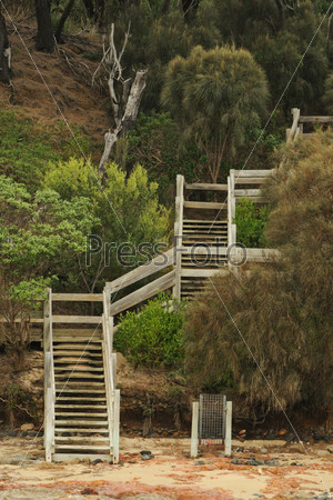 Step pattern in staircase crossing the high hill at shore in diagonal steps, in australian bush in Victoria