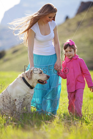 Happy family walking with dog