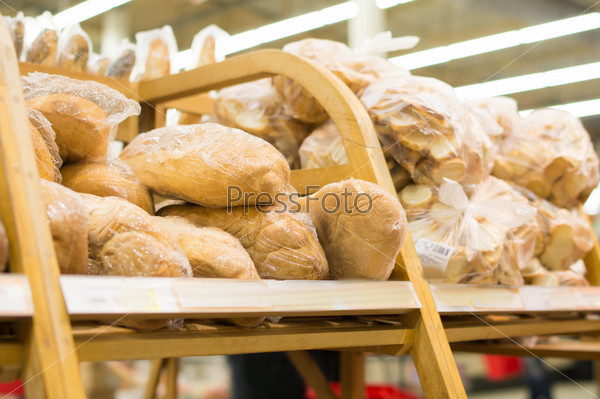 Variety of long loaf bread on shelf in supermarket