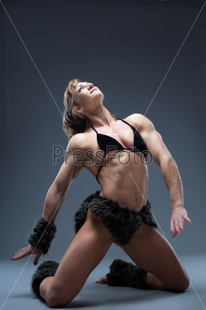 Aggressive woman posing in amazon fur costume