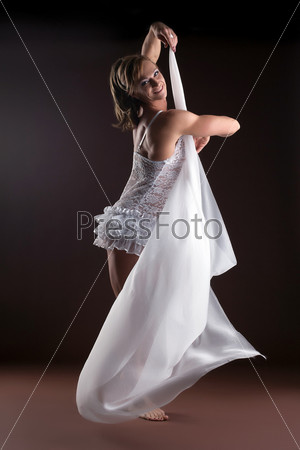 Strong woman body builder with flying veil
