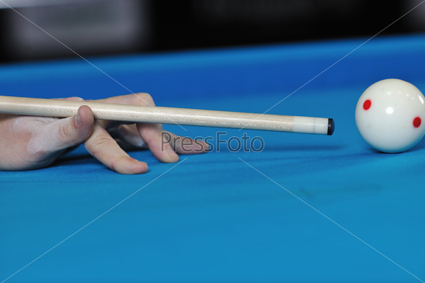 Young pro billiard player finding best solution and right angle at billard or snooker pool sport game , stock photo