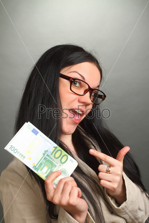 the girl the brunette wearing spectacles holds a roll of money and points a finger at them