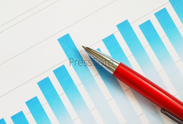 Red pen on finance document with bar graph