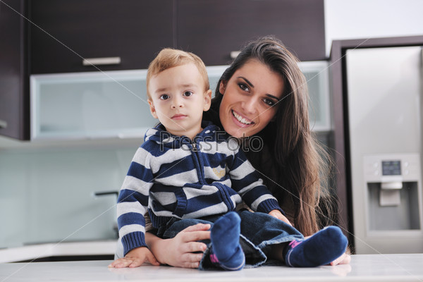 portrait of a happy mom and son together in modern living room home indoor
